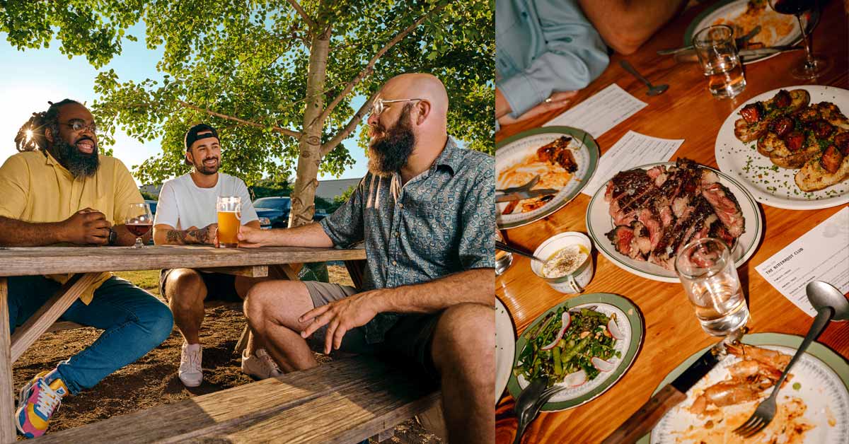 three men drinking beer outside and food at a table