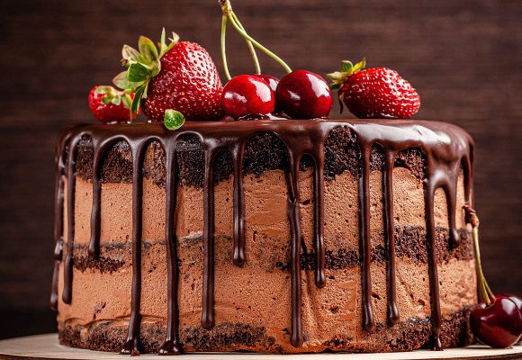 chocolate layer cake covered in fruit