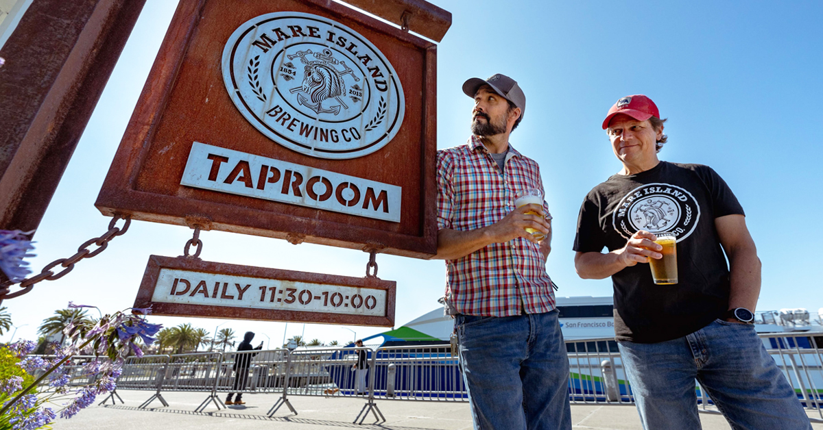 mare island brewing co founders standing at sign